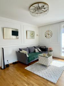 a living room with a couch and a table at Apartament Nadmorski Dwór- Gdańsk in Gdańsk