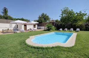 a swimming pool in the middle of a yard at Villa Carmen in Ronda