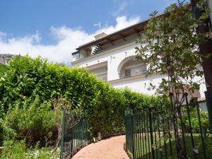 a fence in front of a white building at Antica Residenza la Vela in Meta +24 photos