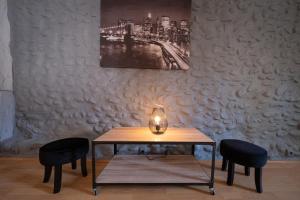 - une table avec deux chaises et une bougie dans l'établissement La Bastide des Cyprès - L'ESCAPADE ADULT ONLY, à Les Mées