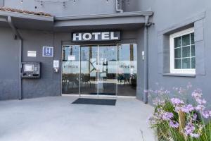 a hotel sign on the front of a building at Hotelet elRetiro in Cambrils