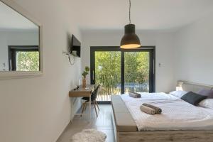 a bedroom with a bed and a desk and a window at Villa Valdo by Istra Vacation in Marčana +37 photos