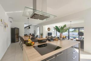 a kitchen with a kitchen island with a counter top at Villa Valdo by Istra Vacation in Marčana