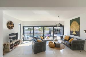 a living room with two couches and a tv at Villa Valdo by Istra Vacation in Marčana