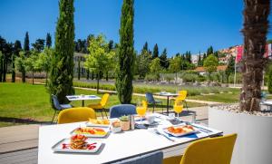 a table with food and drinks on a patio at Akademis Academia in Dubrovnik