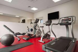 a gym with several exercise bikes and a flat screen tv at Ramada Encore Newcastle-Gateshead in Newcastle upon Tyne