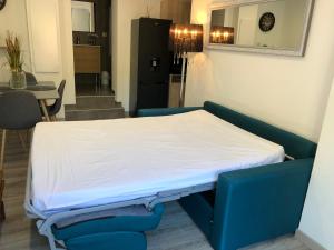 a bed in a room with a table and chairs at Charmant appartement à Ajaccio in Ajaccio +12 photos