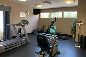 a room with a gym with a treadmill and exercise equipment at Wingate by Wyndham Ashland in Ashland