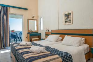 Posteľ alebo postele v izbe v ubytovaní Porto Skala Village Hotel