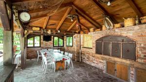 a dining room with a table and a clock on the wall at Holiday Home Emir in Račić