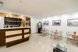 a bar in a restaurant with tables and chairs at TipTop Hotel CITY CENTER in Chişinău