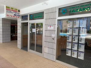 a store front with glass doors and signs on it at SERVICE APART LAZARO - Apartamentos Aguamarina 43-C in Calpe