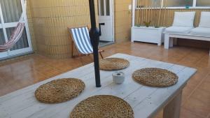 une table en bois avec des sphères au-dessus de celle-ci dans l'établissement Refúgio da Praia, à Furadouro