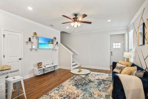 a living room with a blue couch and a ceiling fan at Luxury San Antonio Home Sleeps 6 in San Antonio