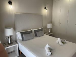 a bedroom with a large white bed with two pillows at Balmes Central Market in Valencia