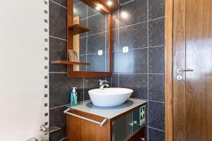 a bathroom with a sink and a mirror at Mindelo Villa Beach by LovelyStay in Mindelo +32 photos