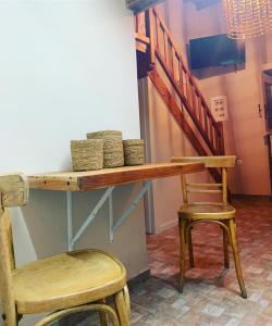 a wooden table with a chair and a staircase at Ikia Wide Wild Summer House in Kollimpithra