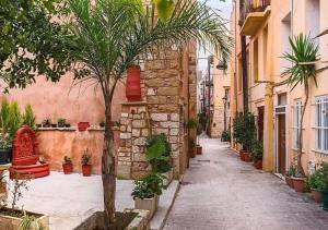 an alley with a palm tree and a building at Estia Residence in Chania Old Town in Chania