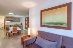 a living room with a couch and a table at Apartamentos Vista Sur in Playa de las Americas
