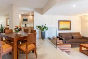 a living room with a table and a couch at Apartamentos Vista Sur in Playa de las Americas