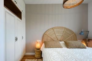 1 dormitorio con 1 cama grande y cabecero de madera en Authentic Beachfront Apartment by Sea N' Rent en Nahariyya