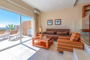 a living room with a couch and a table at Apartamentos Vista Sur in Playa de las Americas