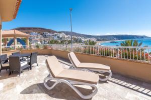 a patio with chairs and a table on a balcony at Apartamentos Vista Sur in Playa de las Americas