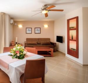 a living room with a table and a couch at Apartamentos Vista Sur in Playa de las Americas