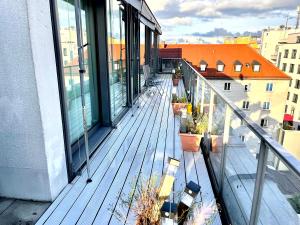 an empty balcony with potted plants on a building at Baynunah Suites Aparthotel in Munich