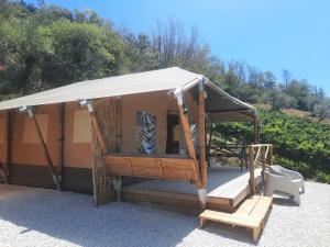 a gazebo with a white canopy and a chair at casavistafiore in Montefiore dellʼAso