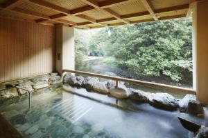 a room with a pool of water with a window at Fudoguchikan in Izumi-Sano +15 photos