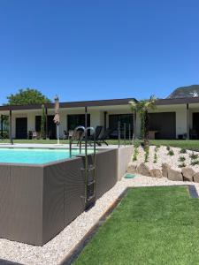 a swimming pool in front of a house at Apartments Klotz in Bolzano