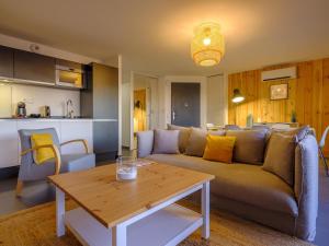 a living room with a couch and a table at Résidence Les Suites Du Ferret in Cap-Ferret