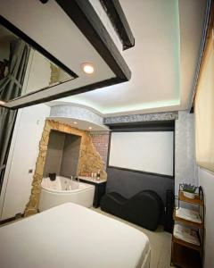 a bedroom with a bathroom with a tub and a sink at Aparta suite la nuit in Calafell