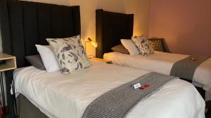 two beds in a hotel room with at The Chameleon Stay @107 in Centurion