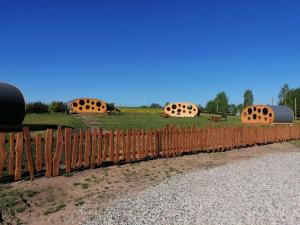 a wooden fence with domes in a field at Vudila Peremajad in Kaiavere