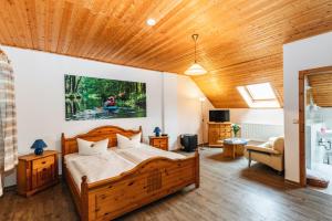 1 dormitorio con 1 cama grande de madera en una habitación en Landgasthof Zur Wildbahn en Burg (Spreewald)