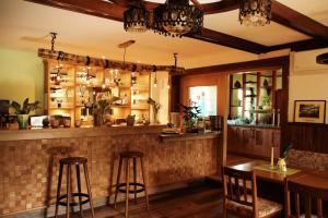 a bar in a restaurant with two stools at Landgasthof Zur Wildbahn in Burg