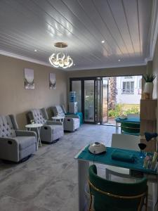 a living room with couches and ping pong tables at St Eve Lodge & Spa in Bloemfontein