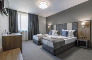 Un pat sau paturi într-o cameră la Hotel complex Jitomir