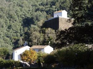 a house on a hill with a lighthouse on it at Casa Lausus in Lousã