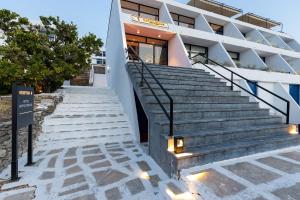 a staircase leading up to a building with lights at Hippocampus Hotel in Naousa
