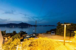 a view of a body of water with cars parked at Hippocampus Hotel in Naousa