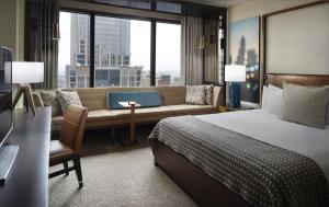 a hotel room with a bed and a couch at Omni Charlotte Hotel in Charlotte