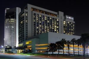 um grande edifício com palmeiras em frente em Omni Corpus Christi Hotel em Corpus Christi