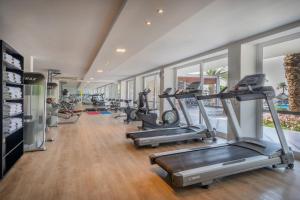 a gym with several treadmills and elliptical machines at Sol Marina Beach Crete in Gouves