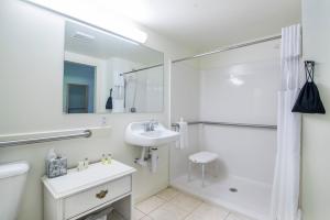 a white bathroom with a sink and a shower at The Lodge at Bretton Woods in Bretton Woods
