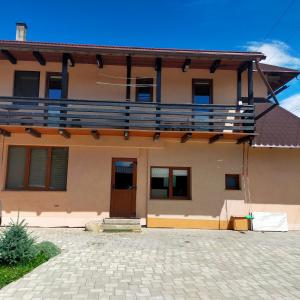 a house with a balcony on top of it at Casa Luna in Gura Humorului