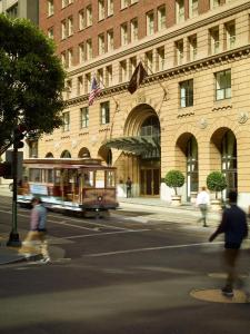 a street scene with a bus and a building at Omni San Francisco in San Francisco