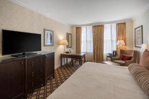 a hotel room with a bed and a flat screen tv at Omni San Francisco in San Francisco